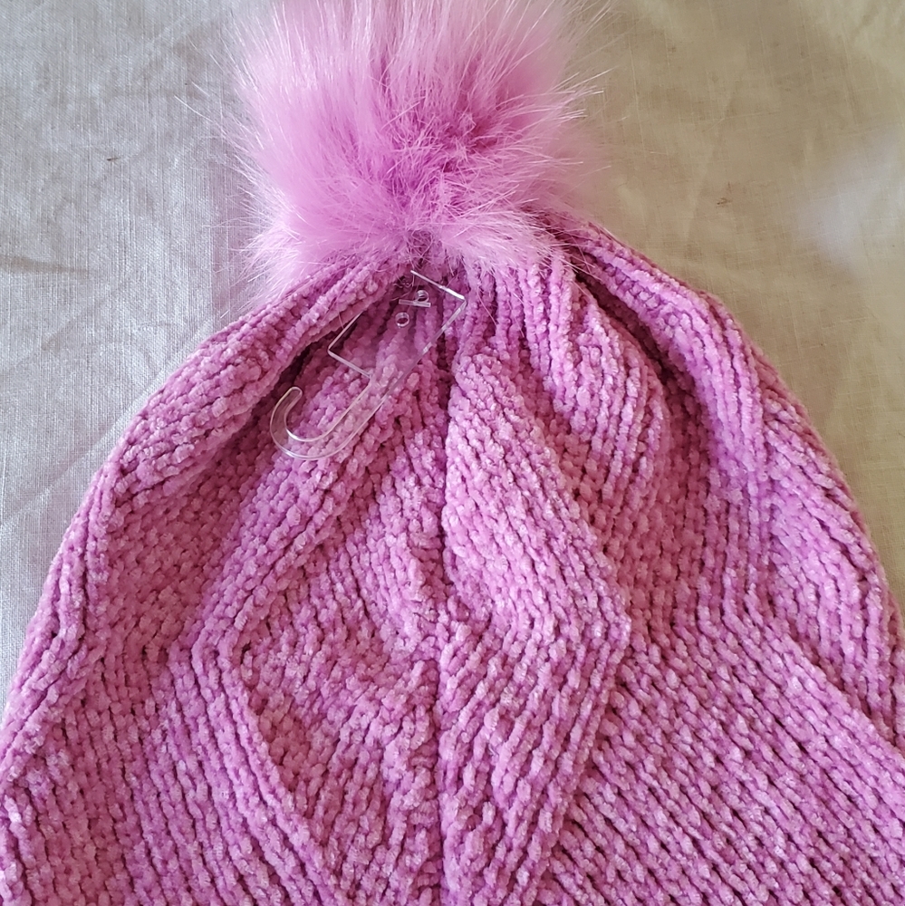 Bright pink knot cap with popm pom on top